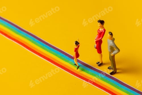 Preview: little parents and daughter figures on the LGBT rainbow path
