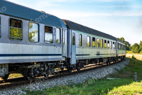 Vista previa: passenger train rides among fields on a sunny day