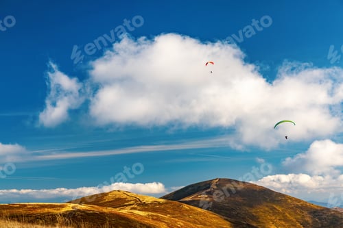 Preview: Paragliding active sport against giant mountains in highland