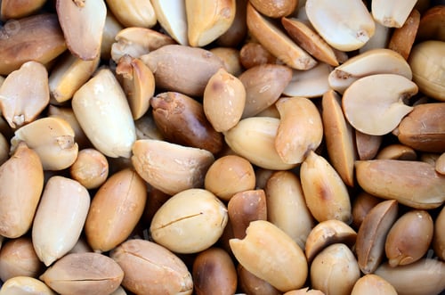Preview: Peanut. A lot of small yellow nuts without peel. Background texture