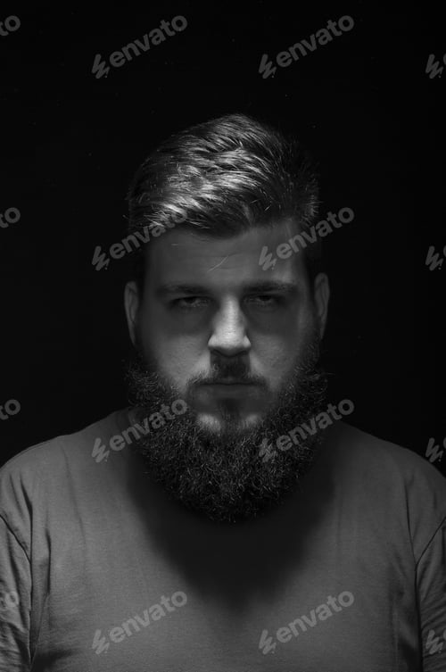 Preview: Bored Mysterious Male Portrait. Low Key, Black Background.