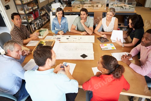 Preview: Group Of Architects Sitting Around Table Having Meeting