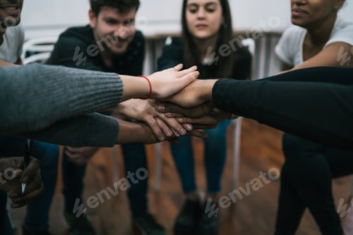 Preview: Team of work showing unity with their hand together.