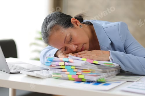 Preview: Senior businesswoman is stressed from doing too much paperwork.