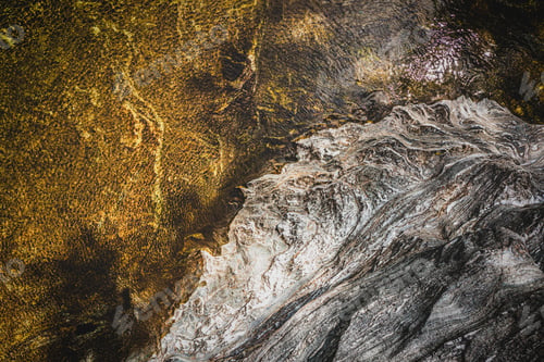 Preview: Top view of the water of a river and a rock bank. The wind gives the whole a superb texture.
