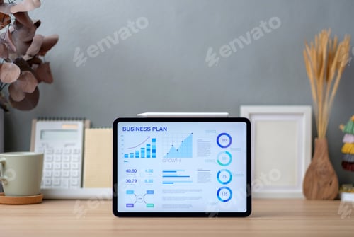 Preview: business plan on tablet on working desk decor with stationery at home