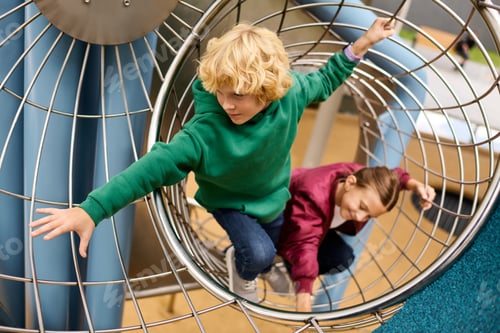 Preview: Children enjoy an autumn afternoon playing on a colorful playground structure full of joy