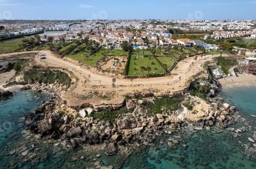Preview: Drone aerial of holiday village with luxury houses at an idyllic rocky coast. Summer vacations