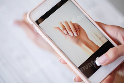 Preview: Woman making photo new manicure on camera her phone