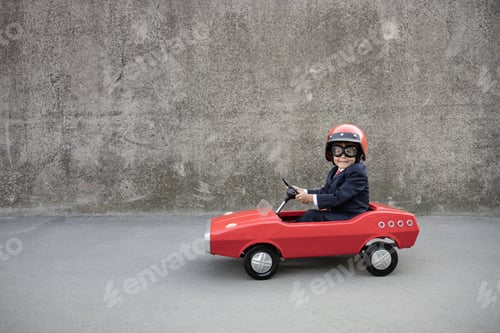 Preview: Funny businessman driving retro pedal car outdoor