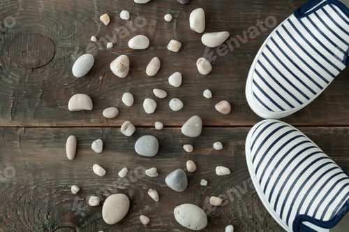 Preview: Shoes and stones on old wooden background