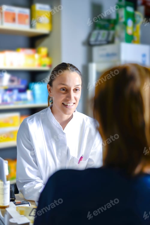 Preview: pharmacist staff counseling customer about drugs usage in modern pharmacy