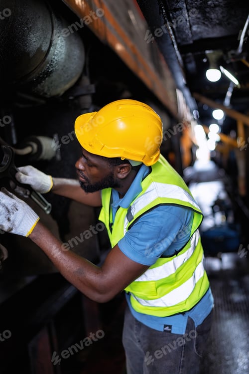 Preview: Engineer railway wearing safety gear checking train transmittal system for safety travel passenger