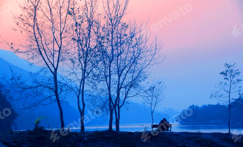 Preview: Rear view of tourist near lake at sunset