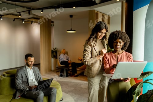 Preview: Collaborative moment at a modern office, shared workspace in mid-afternoon