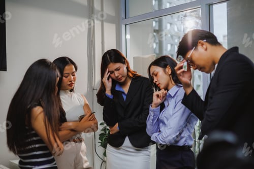 Preview: Asian businesspeople experiencing stress and burnout in office meeting