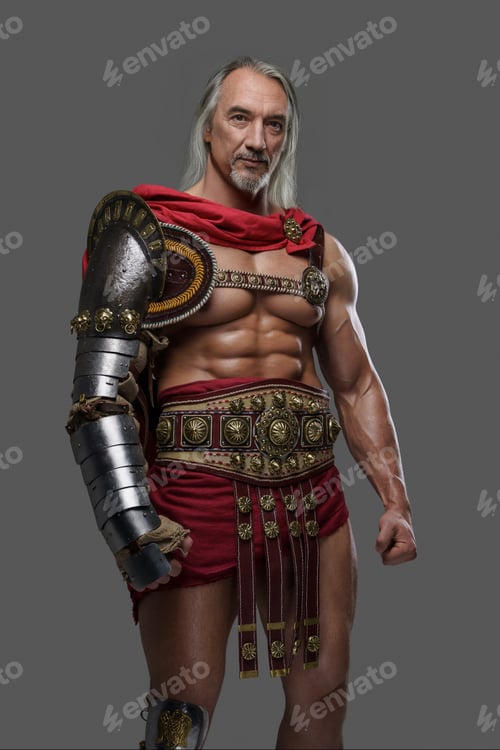 Preview: Mature and muscular gladiator in lightweight armor posing against grey backdrop