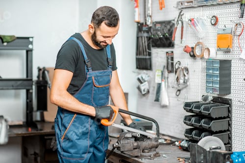 Preview: Handyman working with metal at the workshop