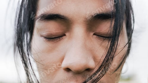 Preview: Close-up of Asian young man with eyes closed