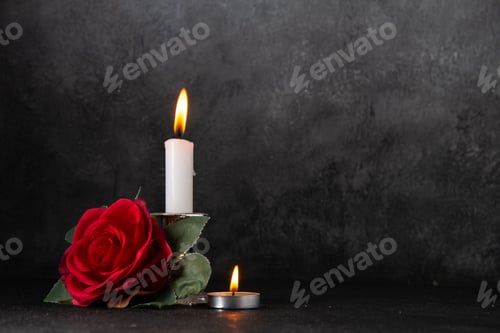 Preview: front view of burning candle with red flower on a gray background tank death war
