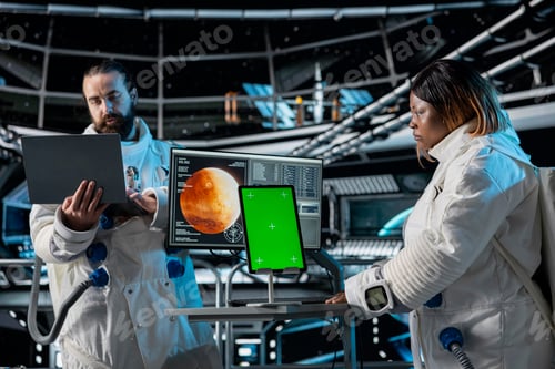 Preview: Orbital station coworkers analyze Mars planetary data using green screen tablet
