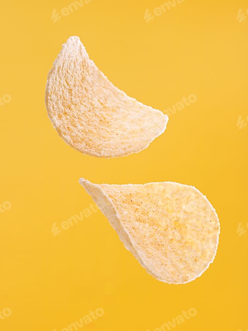 Preview: Vertical shot of potato chips against a vibrant yellow backdrop