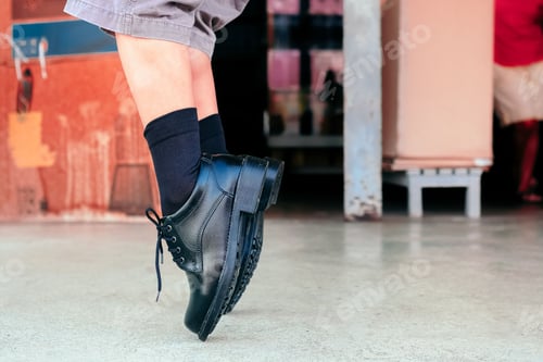 Preview: Closeup of a male on a toe stand pose wearing black lace-up leather shoes