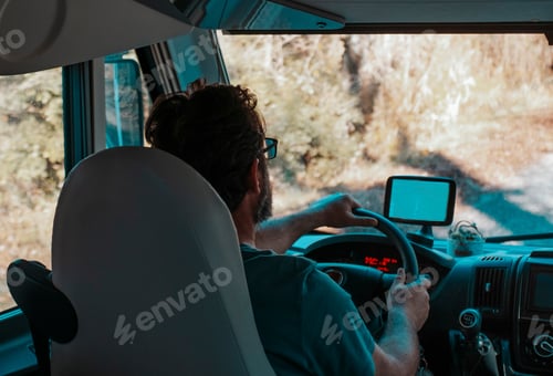 Preview: One man driving big camper van on the road viewed from interior. Concept of travel people