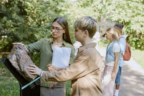 Preview: Botanist Showing Petrified Log To Teenager