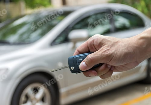 Preview: Hand holding the keys over photo blurred of used car for open the door car,