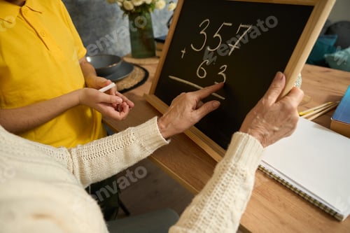Preview: Lady helping grandson study math at home