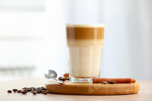 Preview: Tasty latte macchiato in glass on wooden table, closeup