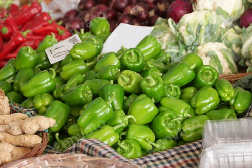 Preview: Display of green peppers at farmers market stall.