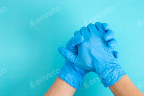 Preview: hands wearing blue glove, holding hands