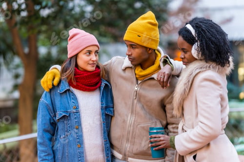 Preview: Three young friends enjoying winter day together in city
