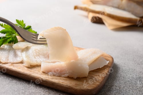 Preview: Man eating delicacy fish smoked halibut. Close up.