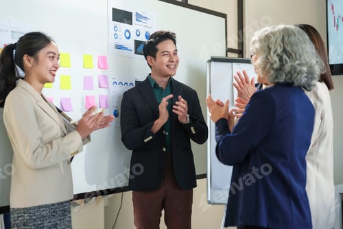 Preview: Business team applauding a successful presentation in the meeting room