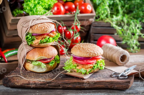 Preview: Delicious takeaway burger on old wooden table