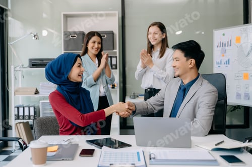 Preview: Business partnership handshake concept.Photo Multiracial team coworkers handshaking process.