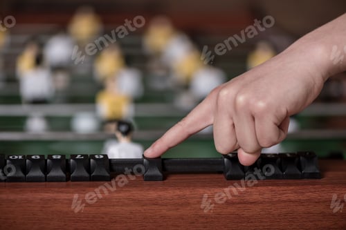 Preview: Close-up view of table football and hand gesturing on score, selective focus