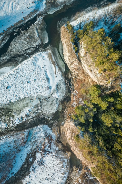 Preview: Frozen Bialka river and Kramnica rock in winter, aerial view