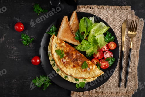 Preview: Omelette with cheese, tomatoes and green herbs. Omelette, salad and toast.