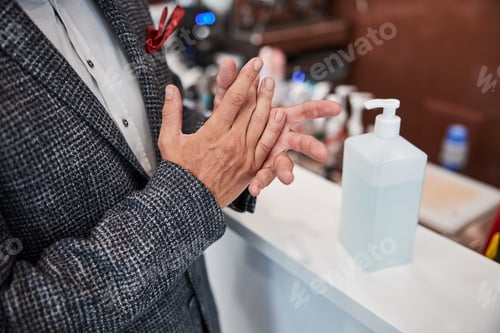 Preview: Gentleman sanitizing his hands at the reception