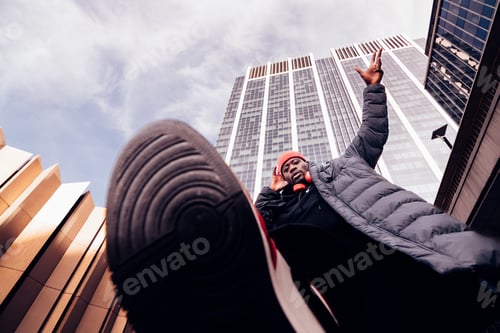 Preview: hip hop man walking above the camera lens under skyscrapers