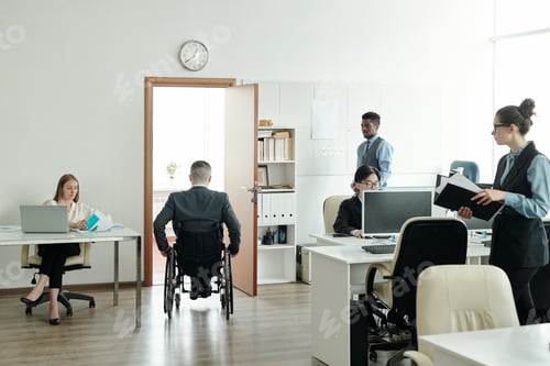 Preview: Businessman in wheelchair moving towards his office