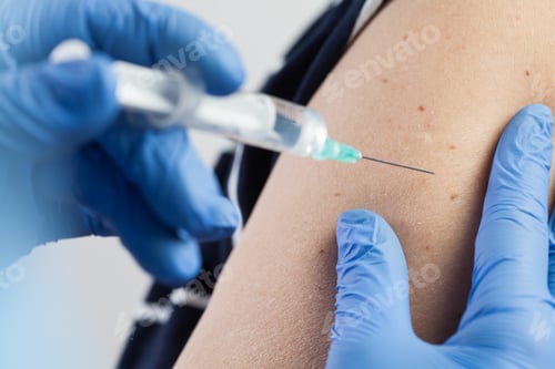 Preview: Medical worker injecting vaccine shot to patients shoulder, arm closeup detail
