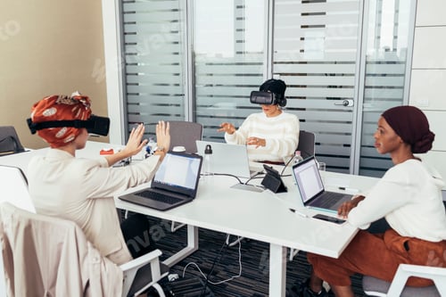 Preview: Colleagues in a modern office explore virtual reality during a creative meeting.