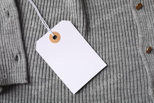 Preview: Cardboard tag on grey garment, top view