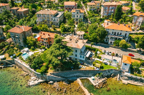Preview: Beautiful villas near the coast of rocky beach in a small town Lovran, Croatia. Arial view of