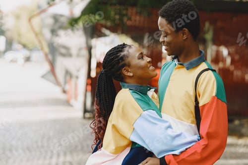 Preview: Ethnic couple walking in city street